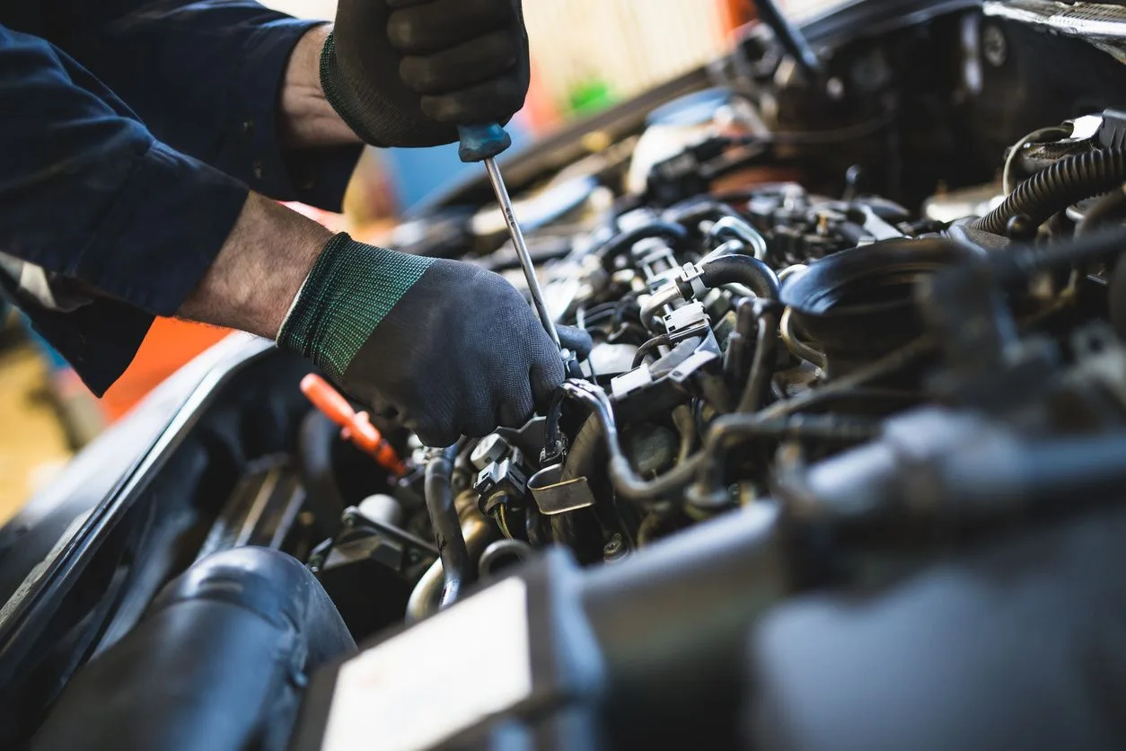 Mechanic servicing an automotive engine